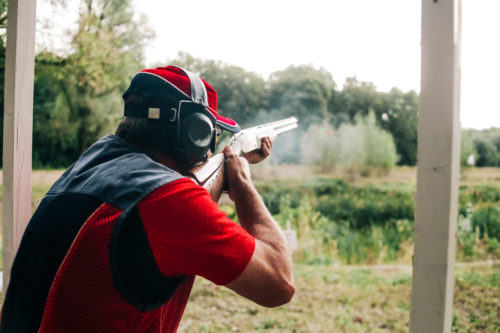 hunter shoots shotgun target special clothes headphones protection auditive chasse